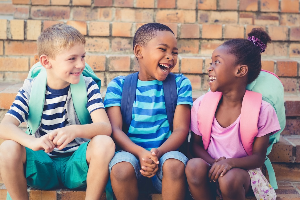 young children of color laughing with each other