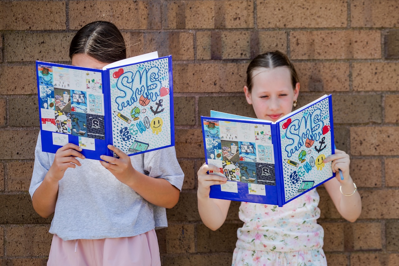 two girls holding up swampscott middle school books two girls holding up swampscott middle school books