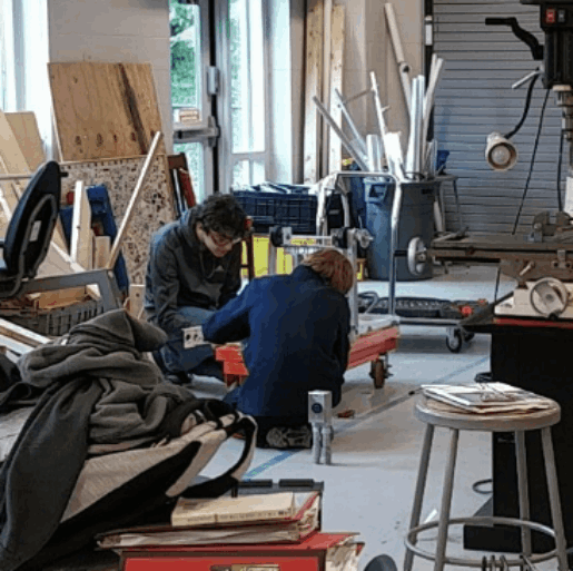 4311 currents robotics team members working on a project